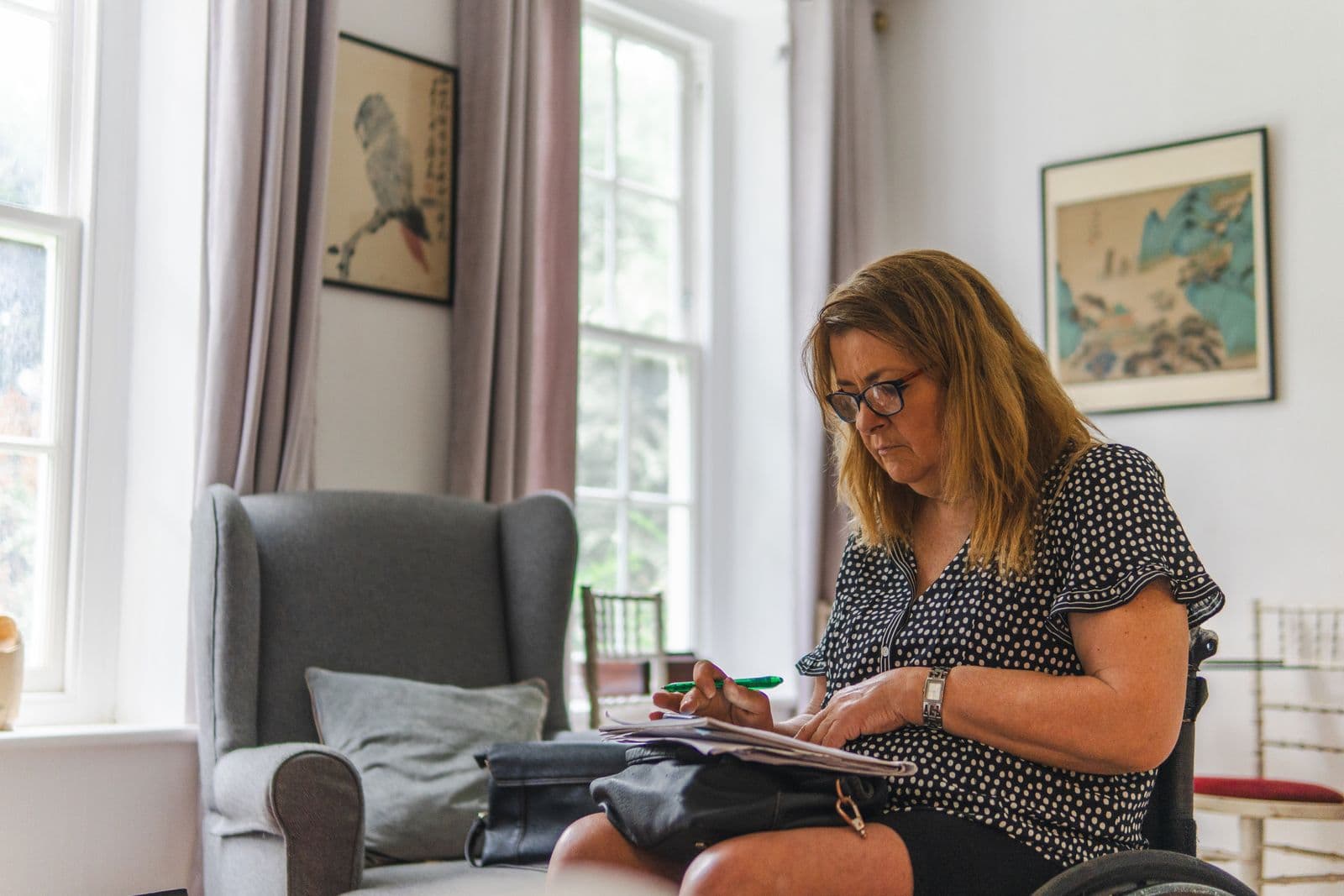 A woman in her sixties making notes at home